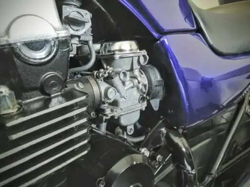Silnik motocykla z gaźnikiem i fioletowym bakiem. Gotowy do dolotu i dalszej jazdy.