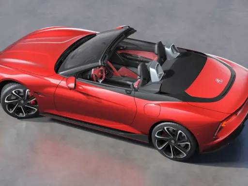 Czerwony mg roadster z czarnym dachem i sportowymi felgami, gotowy na przejażdżkę.