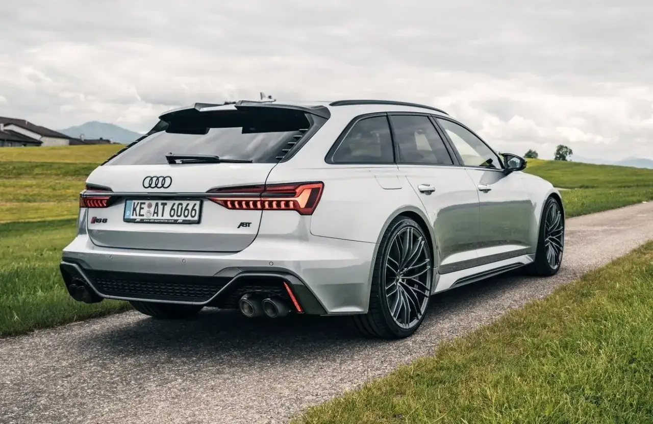 Srebrne Audi RS6 na tle zielonych wzgórz. Zastanawiasz się nad audi rs6 cena? Ten potężny kombi zachwyca designem i osiągami.