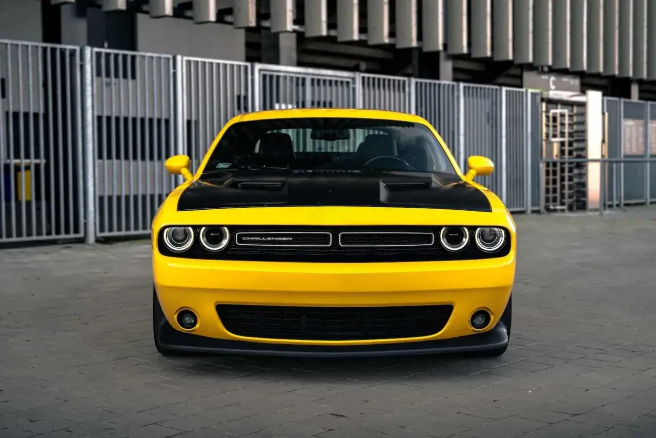 Żółty Dodge Challenger Hellcat z czarną maską, gotowy do jazdy.